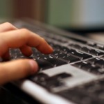 Doctor typing on keyboard using web-based EMR